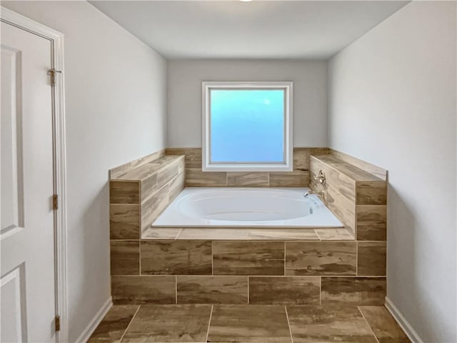 bathroom featuring tiled bath