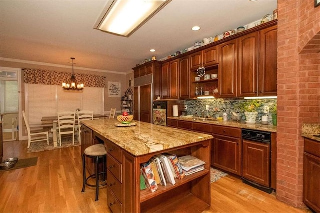 kitchen featuring a kitchen island, light hardwood / wood-style flooring, decorative light fixtures, and a notable chandelier