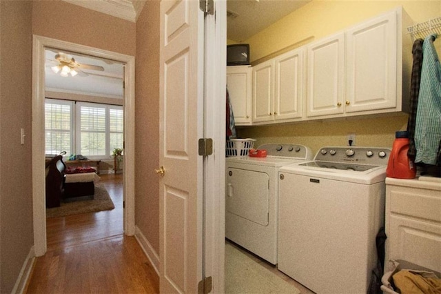 laundry area with light hardwood / wood-style floors, cabinets, ceiling fan, and independent washer and dryer