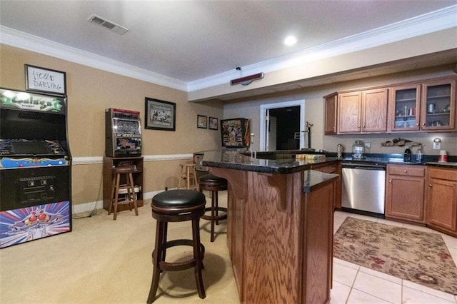 bar with stainless steel dishwasher, ornamental molding, and light tile patterned flooring