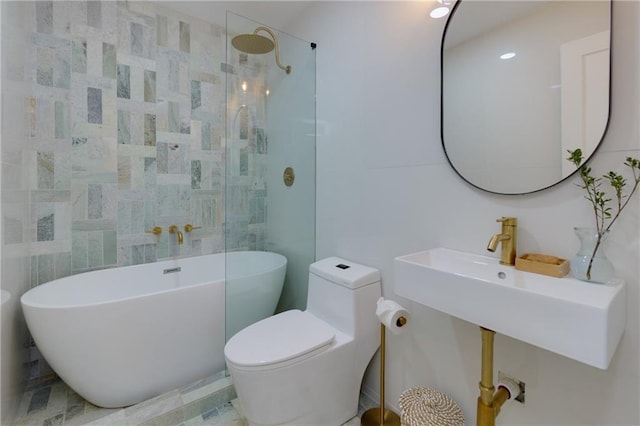 full bathroom with toilet, a sink, tile walls, a soaking tub, and walk in shower