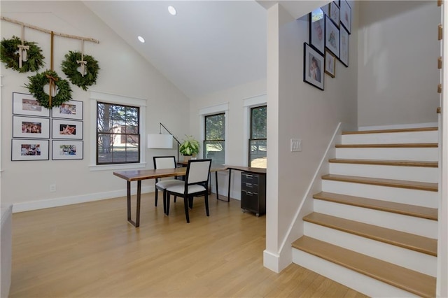 office area featuring high vaulted ceiling, recessed lighting, light wood-type flooring, and baseboards