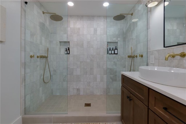 full bathroom featuring a walk in shower and vanity