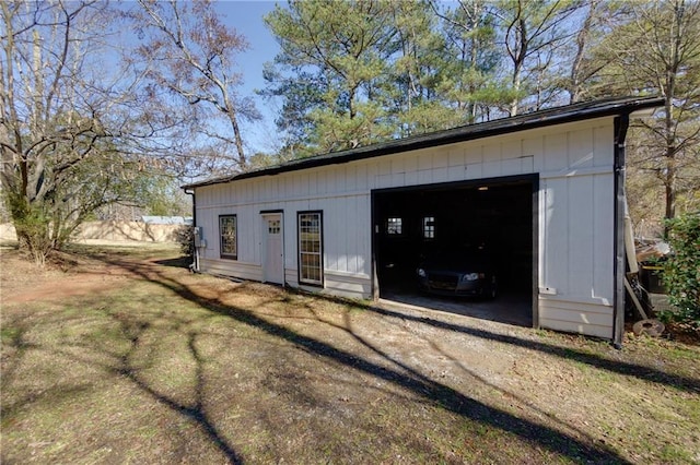 view of outbuilding with driveway and an outbuilding