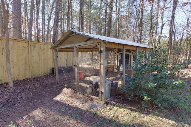 exterior space featuring a carport and fence