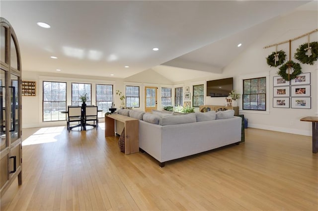 living room with light wood-type flooring, high vaulted ceiling, baseboards, and recessed lighting