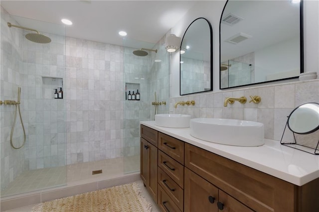 full bath with visible vents, a walk in shower, and a sink