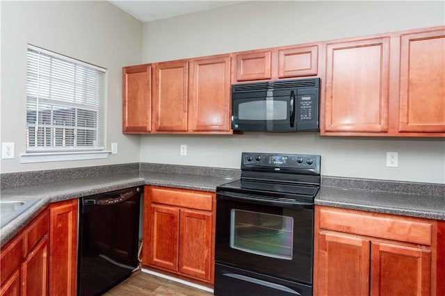 2384 Coach Way, Jonesboro, GA 30236 - kitchen with black appliances, dark countertops, brown cabinets, and wood finished floors