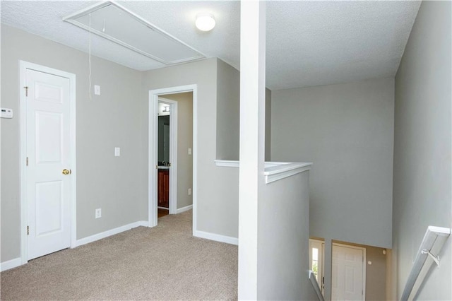 2384 Coach Way, Jonesboro, GA 30236 - hall with carpet floors, attic access, an upstairs landing, baseboards, and a textured ceiling