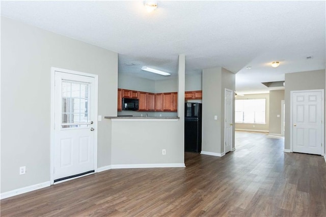 2384 Coach Way, Jonesboro, GA 30236 - unfurnished living room with dark wood-type flooring and baseboards