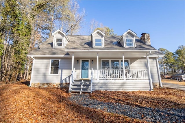 cape cod-style house featuring covered porch