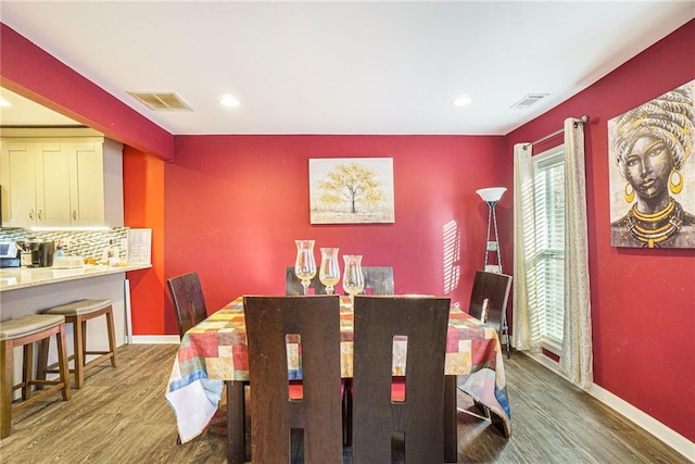 dining area with dark hardwood / wood-style flooring