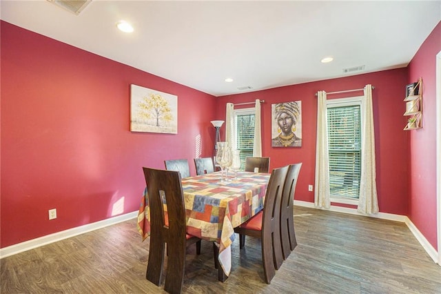 dining area with plenty of natural light and dark hardwood / wood-style floors