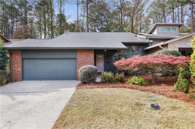 view of front of home featuring a garage and a front lawn