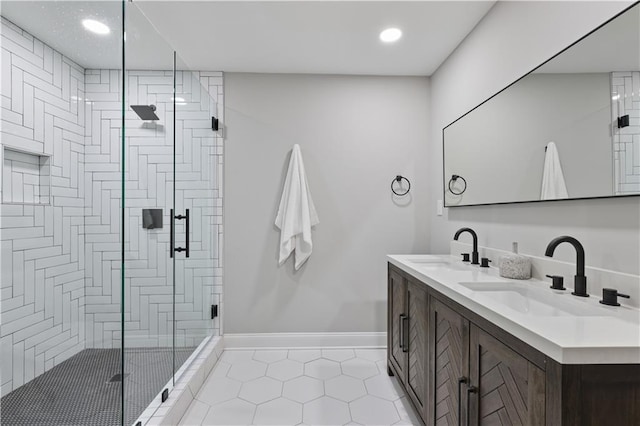 bathroom featuring tile patterned flooring, vanity, and a shower with door