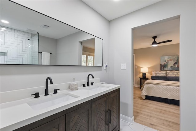 bathroom featuring wood-type flooring, vanity, and ceiling fan