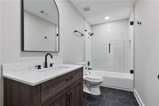 full bathroom with tile patterned flooring, vanity, toilet, and tiled shower / bath combo