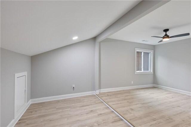 additional living space with beam ceiling, light hardwood / wood-style flooring, and ceiling fan