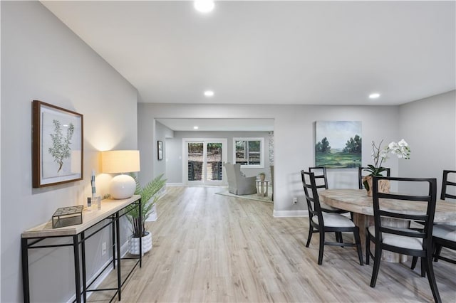 dining space with light hardwood / wood-style flooring