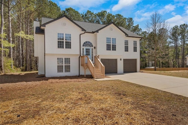 bi-level home with driveway and a garage