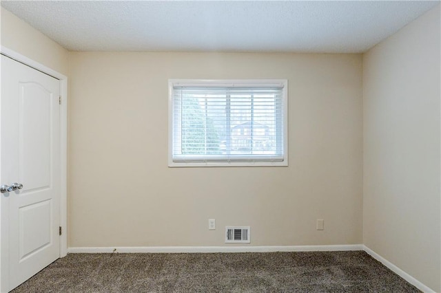 unfurnished bedroom featuring visible vents, carpet flooring, and baseboards