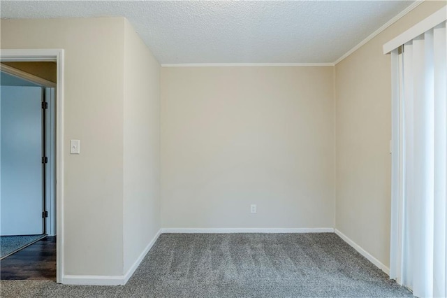 carpeted spare room featuring baseboards and a textured ceiling