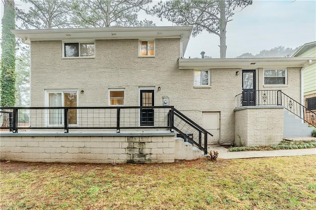 exterior space featuring a yard and brick siding