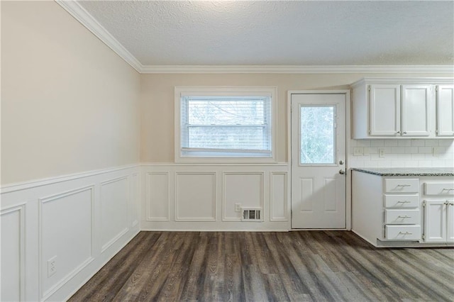 interior space with visible vents, plenty of natural light, a textured ceiling, and dark wood-style floors