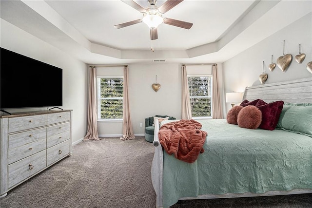 7086 Gladstone Cir, Lithonia, GA 30038 - carpeted bedroom featuring a raised ceiling, multiple windows, and ceiling fan