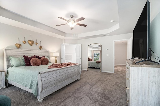 7086 Gladstone Cir, Lithonia, GA 30038 - bedroom featuring a tray ceiling, carpet floors, arched walkways, and ceiling fan