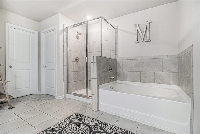 7086 Gladstone Cir, Lithonia, GA 30038 - bathroom with a garden tub, a stall shower, and tile patterned floors