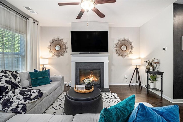 7086 Gladstone Cir, Lithonia, GA 30038 - living room featuring wood finished floors, ceiling fan, and a fireplace with flush hearth