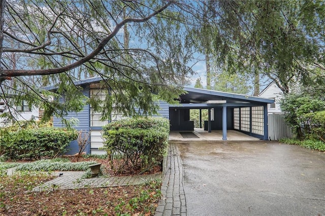 view of front of house with aphalt driveway and a carport