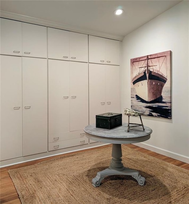 interior details featuring baseboards, wood finished floors, and recessed lighting