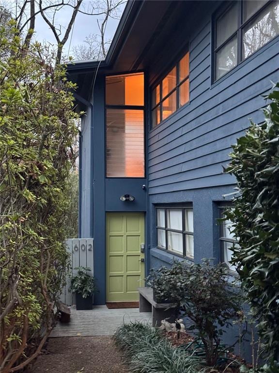 entrance to property featuring stucco siding