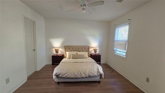 bedroom with a ceiling fan, baseboards, and wood finished floors