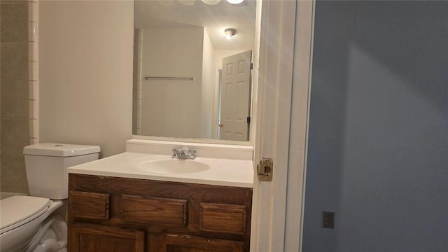 bathroom with toilet and vanity