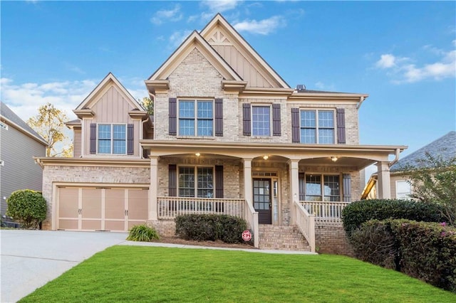 craftsman house with covered porch, a garage, and a front lawn