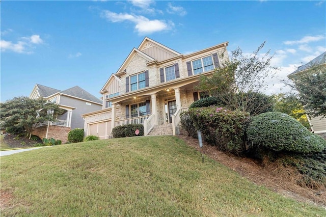 craftsman-style house with a front yard, a garage, and a porch