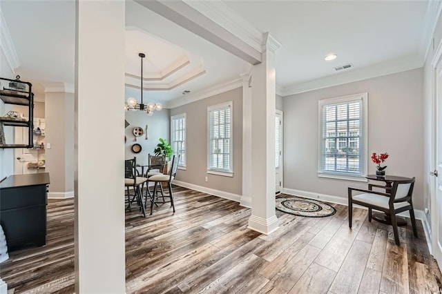 dining space with wood-type flooring and crown molding