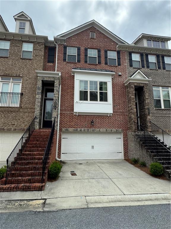 4172 Townsend Ln, Dunwoody, GA 30346 - multi unit property featuring a garage, concrete driveway, brick siding, and stairs