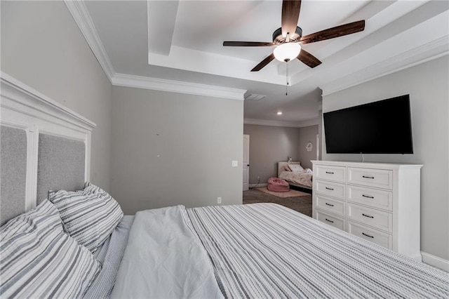 carpeted bedroom with crown molding, ceiling fan, and a raised ceiling