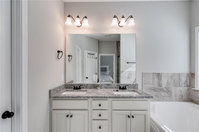 bathroom with vanity and a bathing tub