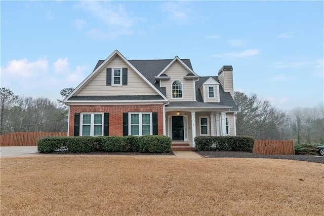 1008 Walnut Creek Dr, Woodstock, GA 30188 - view of front of home with fence, brick siding, a porch, a front yard, and a chimney