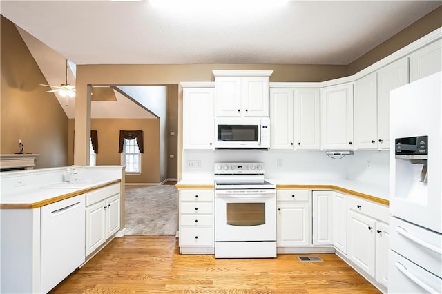 1008 Walnut Creek Dr, Woodstock, GA 30188 - kitchen featuring white appliances, visible vents, a sink, and light countertops