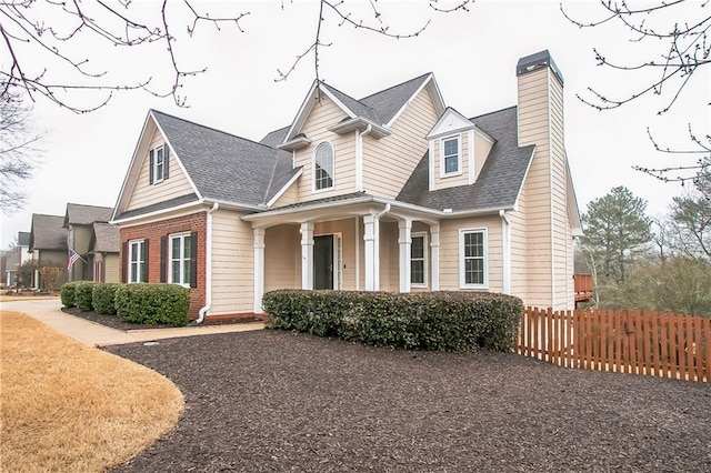 1008 Walnut Creek Dr, Woodstock, GA 30188 - new england style home with fence, a chimney, and roof with shingles
