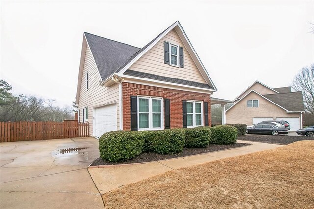 1008 Walnut Creek Dr, Woodstock, GA 30188 - view of property exterior featuring brick siding, fence, driveway, and a shingled roof