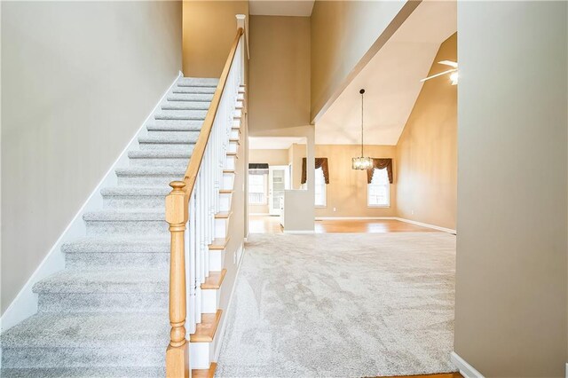 1008 Walnut Creek Dr, Woodstock, GA 30188 - stairs with an inviting chandelier, carpet floors, baseboards, and a towering ceiling