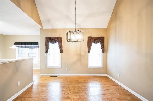 1008 Walnut Creek Dr, Woodstock, GA 30188 - unfurnished dining area featuring visible vents, baseboards, a notable chandelier, and lofted ceiling