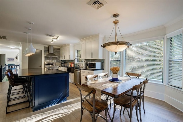 2316 Mountain Crest Pl, Gainesville, GA 30501 - dining space with light wood finished floors and ornamental molding